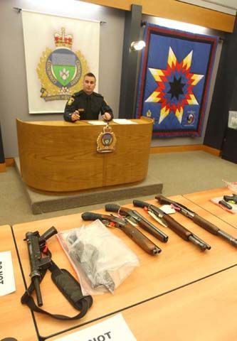 diyselfdefense: A submachine-gun and a half dozen sawed off shotguns seized during a gang house raid