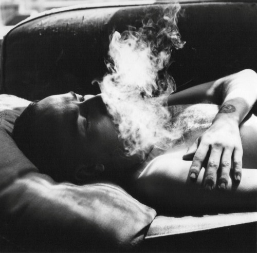 kathrynkane:  Man on a couch with smoke,