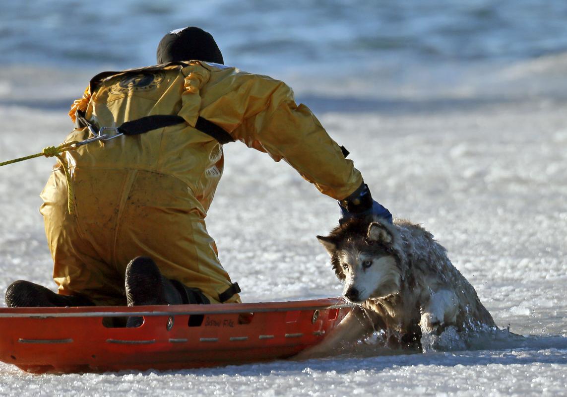 awkwardsituationist:  photos by mark garfinkel of boston firefighter sean coyle rescuing