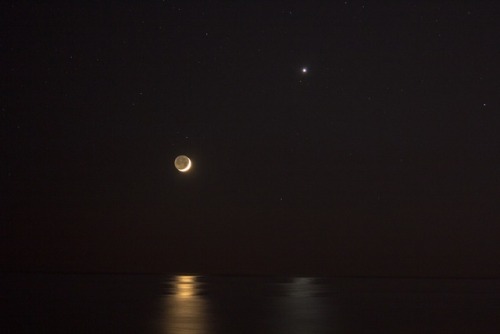 just–space:  Reflections of Venus and Moon : Posing near the western horizon, a brilliant evening star and slender young crescent shared reflections in a calm sea last Thursday after sunset. Recorded in this snapshot from the Atlantic beach at Santa