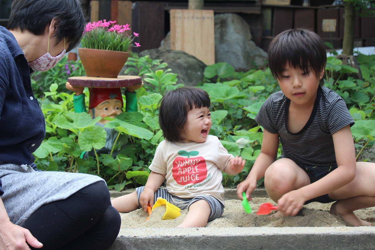 at the yard of our new house, with her grand mother and her cousin.