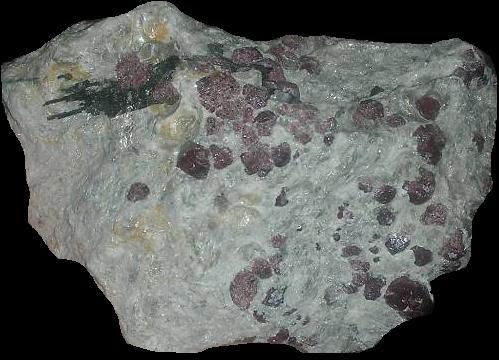 fuckyeahmineralogy:  Almandine, a type of garnet, in various stages of preparation.  Fully embedded in the matrix, as it would most commonly be found, and also jutting out of the matrix (I’m actually not sure if you find them like this, or if this