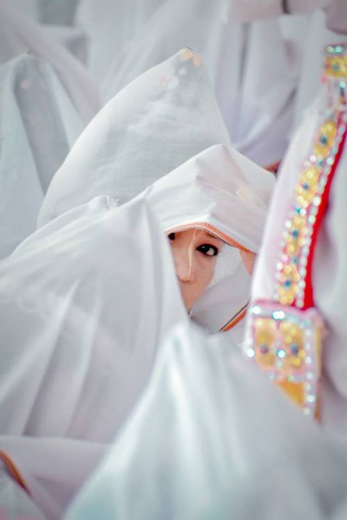 Hidden faces, Beautiful veiled woman protecting themselves from the colored powders, Holi Festival a