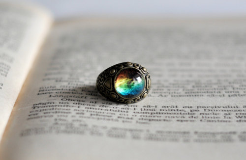 chipmunktheseaotter:  wickedclothes:  Antique Brass Galaxy Ring Crafted out of antique brass. This ring features a lovely depiction of a nebula and has a beautiful pattern carved on the sides. Sold on Etsy.  I want the galaxy on my finger. 