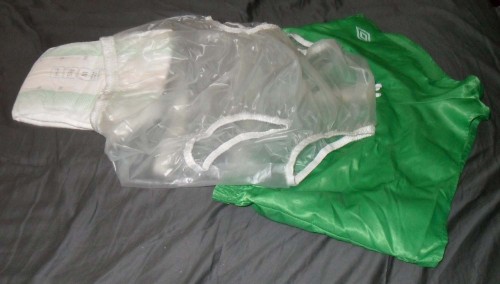 Waiting to be put on.  Diaper for wetting, infantile, plastic pants for security and feel, infantine
