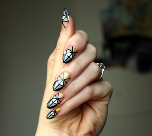 ladycrappo:  I’m not sure if these even qualify as half moons.  Sometimes I start painting with a vary vague idea in my head and it takes on its own life as I go. These nails just wanted to be a badass geometric, who am I to stand in their way? 31DC2014