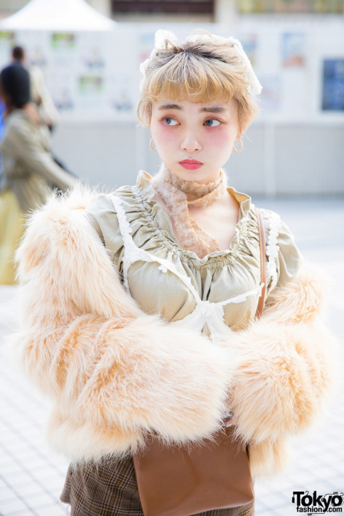 20-year-old Eartha on the street in Tokyo wearing a faux fur coat over a lingerie top from Melange H