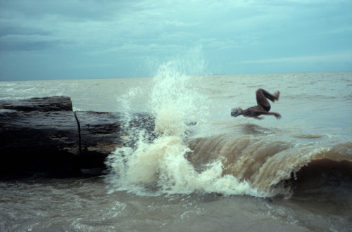 20aliens: BRAZIL. Mosquiero Island. 1993. Leaping into river surf.Alex Webb