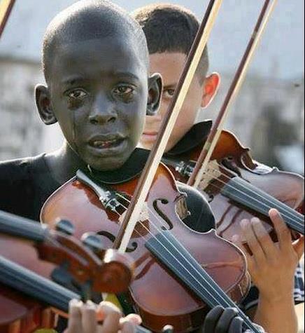 powermeditation:  Children play at the funeral of their music teacher 