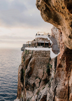 visualjunkee:“Terraces of the Coba d’en Xoroi bar and nightclub, which is set into cliffside caves that overlook the sea in Cala en Porter.” - location: Menorca, Spain - photography: Salva López - Travel + Leisure August 2017