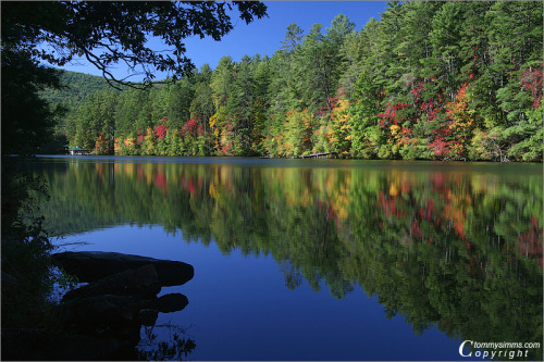 The colors of a beautiful north Georgia autumn adorn the shores of Nacoochee Lake, Rabun County, Geo