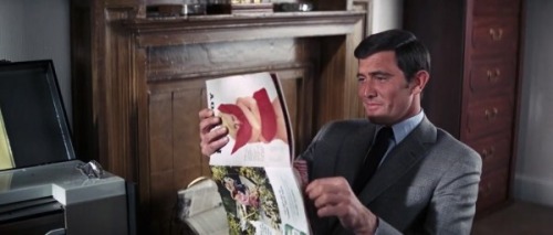 dollsofthe1960s:  James Bond (played by George Lazenby) seen above enjoying his February 1969 Playboy issue in “On Her Majesty’s Secret Service (1969).”  GRINDHOUSE® 007