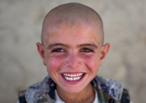 Smiling afghan boy with head shaved, Badakhshan province, Khandood, Afghanistan. Taken on August 13,