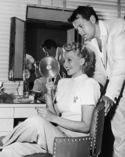 fuckyesoldhollywood:  Rita Hayworth looks at her reflection after her famous red hair was cut and dyed blonde on the set of ‘The Lady From Shanghai’, as Orson Welles looks on For a caption, that was a mouthful. 