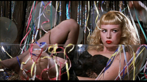 Traci Lords as Wanda Woodward