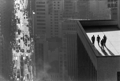 I love this iconic shot. The “men on rooftop” look like gangsters or spies with the urba