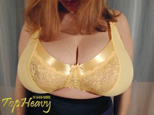 smushedbreasts:  Bursting out of a tight 34JJ bra!!