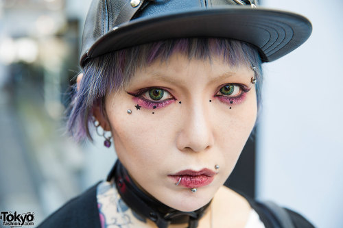 Yui on the street in Harajuku wearing a leather harness cap, a Worlds End t-shirt, skinny jeans, Dr.