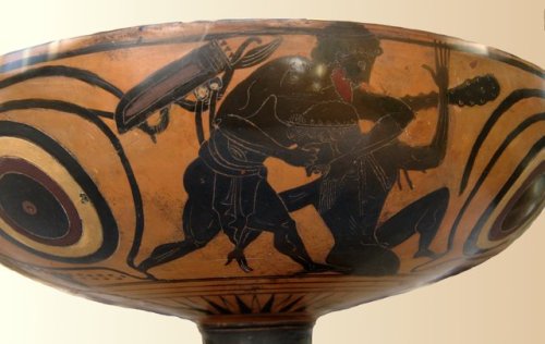 Heracles wrestles a figure variously identified as Alcyoneus or Antaeus.  Attic black-figure eye-cup