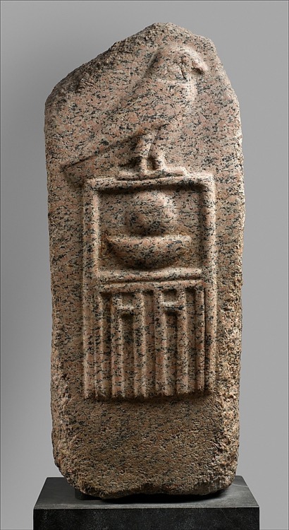 ancientpeoples:Pink granite stele of Ra-Neb The stele shows the god Horus standing on a palace (the 