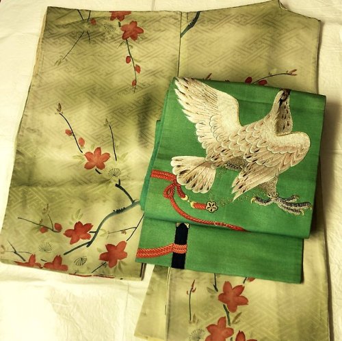 Muted Cherry blossoms kimono paired with an impressive embroidered obi with hunting hawk, and up fro