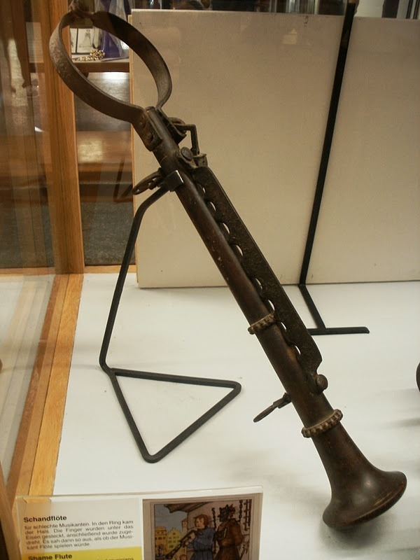 Shame Flute. The round part goes around the neck and the finger are smashed beneath
