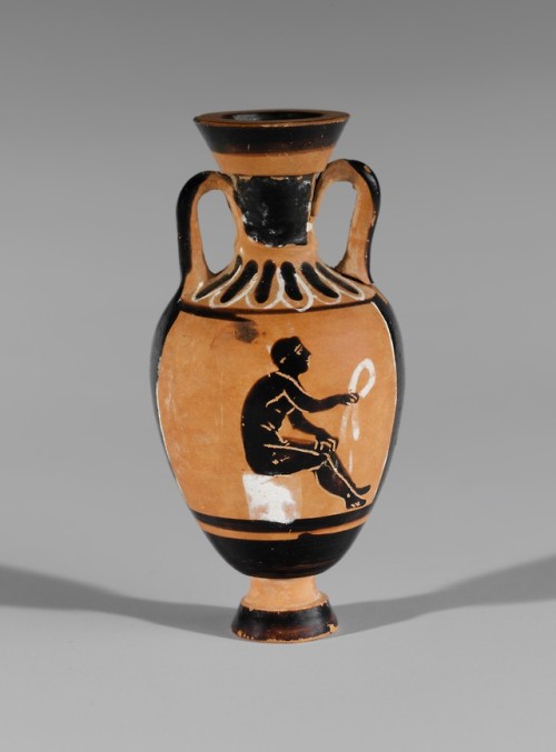 A seated athlete holds a fillet (?)  Miniature black-figure Panathenaic amphora, attr. to the B