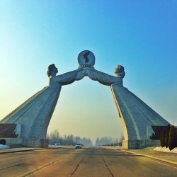 naenara:  Monument to the Three Charters for National Reunification. Erected in 2001 to commemorate reunification proposals put forth by Kim Il Sung, the monument watches over the Pyongyang-Kaesong highway. 