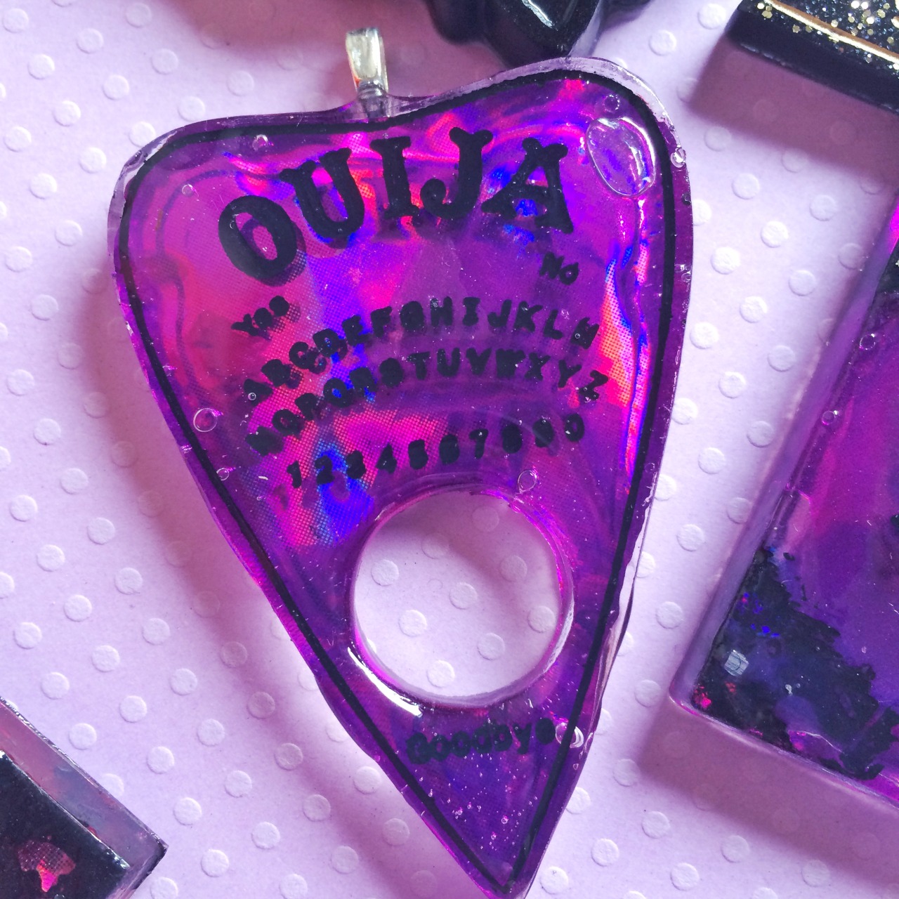 jinxandcurses:  NEW! Holographic ouija boards in planchettes in pink, purple, blue,