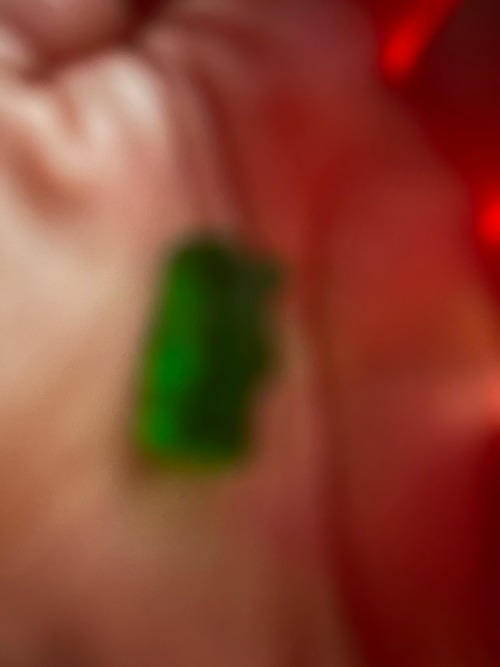 a green gummy bear in my hand