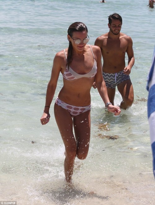 Katie Cassidy sprints out of the water in a bikini in Miami
