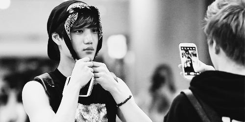 jongins:  suho messing around with kai’s bandana and taking photos of him 