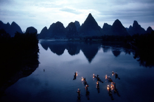 Burt Glinn. CHINA, KWEILIN, 1981 fishermen using cormorant and lanterns to fish in dusk