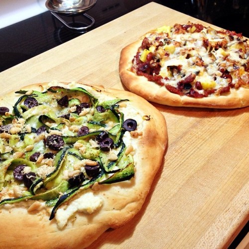 Dinner tonight: Marinated zucchini and ricotta pizza with pine nuts and kalamata olives and prosciutto and pineapple pizza with mushrooms and shallots.