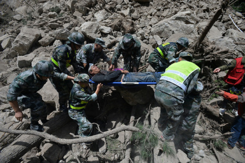 Chinese paramilitary police carry a survivor after an 7.0-magnitude earthquake in Jiuzhaigou county,