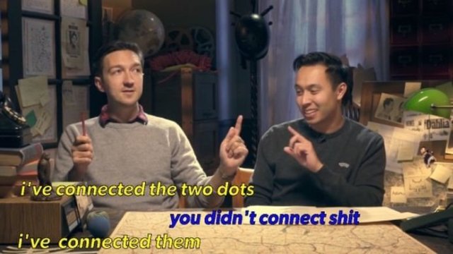 A screenshot from BuzzFeed unsolved. It shows two men sat together at a desk. The text reads: [yellow] I've connected the two dots. [Blue] you didn't connect shit. [Yellow] I've connected them.