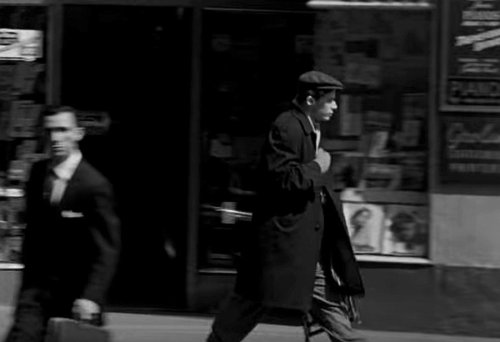 Glenn Gould walking in NY, holding his chair