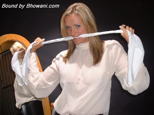graybandanna:  Lucy Zara gags herself in the mirror with a white scarf before being tied to a chair, gagged with another scarf and blindfolded 