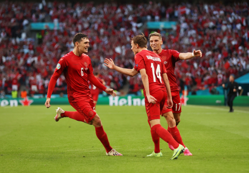 Mikkel Damsgaard celebrates his goal with teammates during the match vs. England