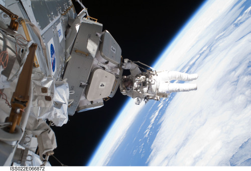 Astronaut Nicholas Patrick hangs from the cupola during the STS-130 mission’s third and final 