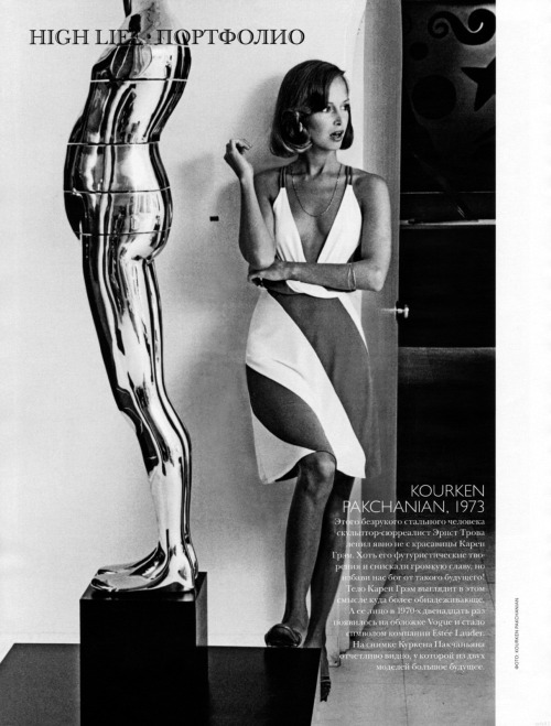Karen Graham in low-cut jersey dress by Neil Brieff stands next to sculpture by Ernest Trova. P