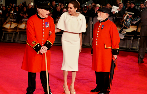 iheart-jolie:  Director Angelina Jolie ,poses with Chelsea Pensioners Cecil Baker and James Walter F