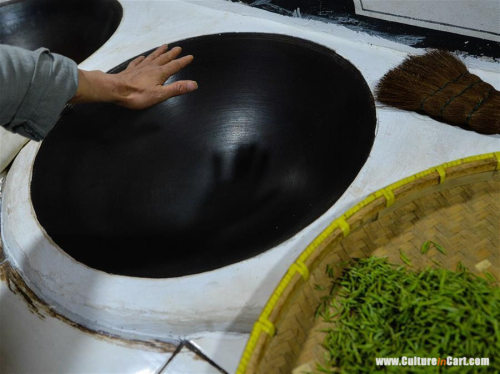 Ancient Making Technique Of Chinese Tea BiluochunYan Jielong dries baked Biluochun tea in Dongshan t