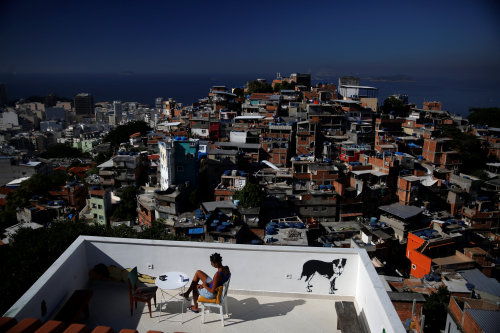 Favela HotelRio de Janeiro, Brazil—A woman sits on a terrace at Tiki hostel in Cantagalo favel