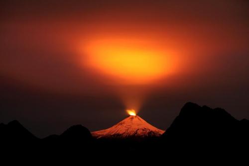 unrar:The Villarrica Volcano is seen at night in Pucon town, Chile. Villarrica, located near the pop