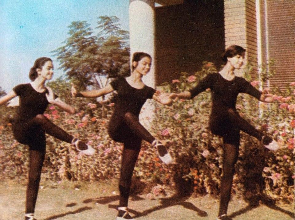 pill:     Girls from the Iraqi National school of Music and Ballet practicing outside,