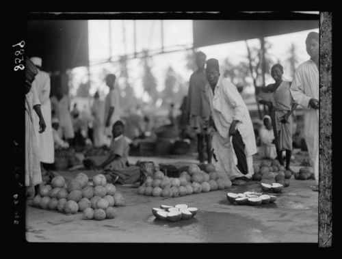 Vegetable market; coconut market; youths in a native market (Dar esSalaam, Tanganyika,
