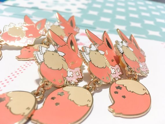 retrogamingblog:  Pikachu and Eevee dangling tail pins made by Toasterkiwi
