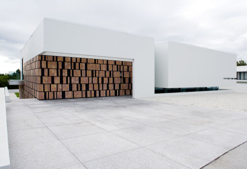 dezeen:  This volcanic stone wall hides a doorway into B25 house by PK Arkitektar