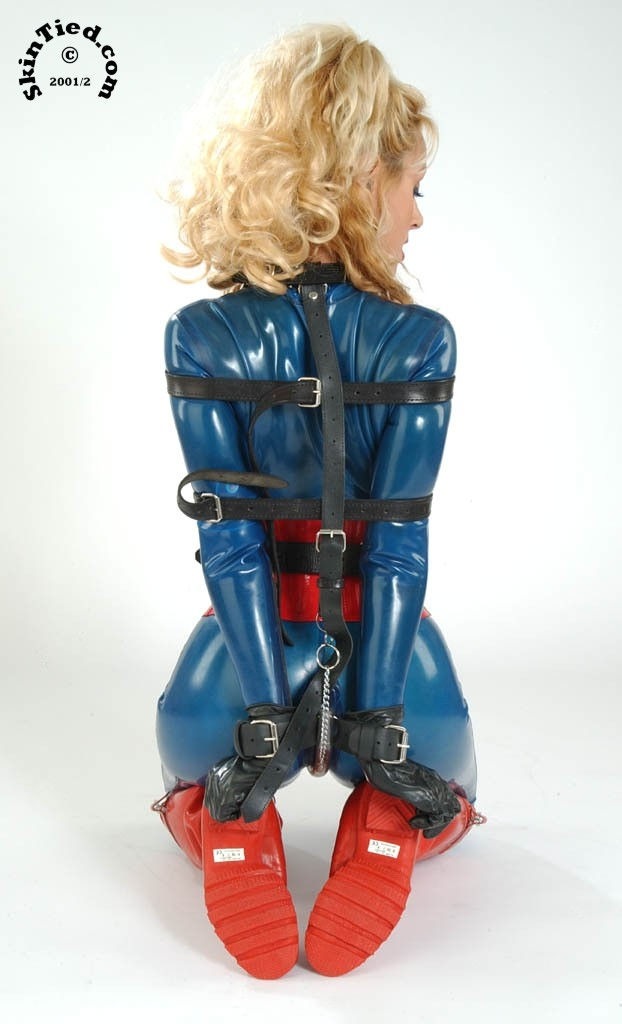 A blonde lady in tight rubber bondage..